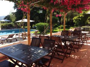 a group of tables and chairs next to a pool at Quinta Verde Sintra - Casa de Campo in Sintra