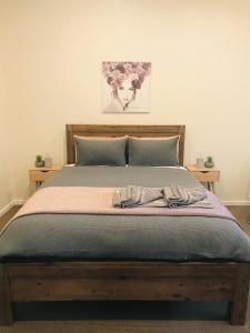 a bedroom with a bed with a wooden head board at Forest View in Creswick