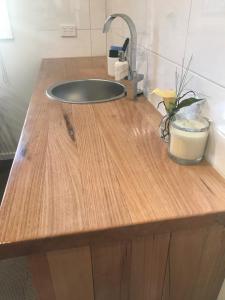 a wooden counter top with a sink in a room at Forest View in Creswick
