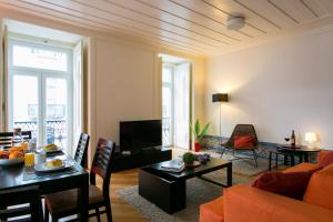 a living room with a couch and a table at ALTIDO Elegant 2BR Apt with workspace nearby Baixa-Chiado subway in Lisbon