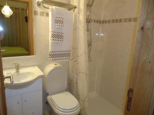 a bathroom with a toilet and a sink and a shower at Quarto in Alvor