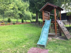 a playground with a slide and a gazebo at CHataBela in Svit