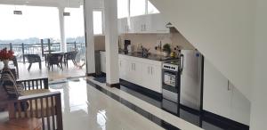a kitchen with white cabinets and a staircase in a house at Fairview Residence in Kandy