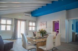a dining room with a table and chairs at Leonidas House in Parga