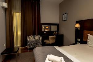 Giường trong phòng chung tại Hotel Dolce International