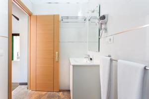 a white bathroom with a sink and a mirror at Casa Las Zocas in San Miguel de Abona +61 photos