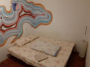 a bed with a blue and white bedspread and pillows at Art Hostel in Lviv