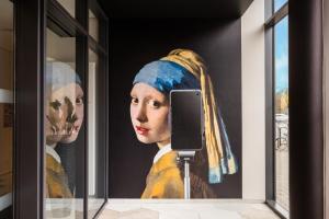 a large painting of a woman with a head at Aparthotel Adagio Köln City in Cologne