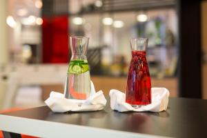 two glass vases sitting on top of a table at Aparthotel Adagio Köln City in Cologne