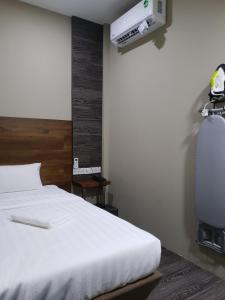 Postel nebo postele na pokoji v ubytování Qing yun resthouse Bandar, Brunei Darussalam