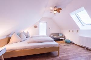 a bedroom with a bed and a ceiling fan at Winzer Suite - Weingut Dietl in Riegersburg