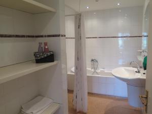 a bathroom with a sink and a toilet and a tub at Café Brasserie Het Heerenhuis in Het Kalf +41 photos