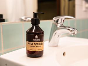 a bottle of moisturizing liquid soap sitting on a bathroom sink at Loft - HI Hostel in Reykjavík
