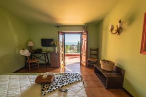 a bedroom with a door open to a balcony at Hotel Villa Sirina in Taormina