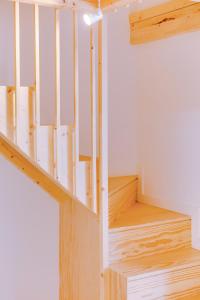 a staircase in a house with wooden floors at A Casa D'Amelie in Faro