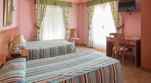 Postel nebo postele na pokoji v ubytování Hotel Real de Castilla