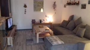a living room with a couch and a table at Ferienwohnung Haus Gintz in Blieskastel