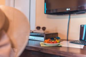 a bowl of fruit on a table with a laptop at Hotel Villa Sirina in Taormina