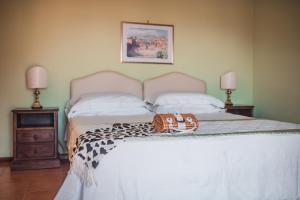 a bedroom with a bed with a purse on it at Hotel Villa Sirina in Taormina