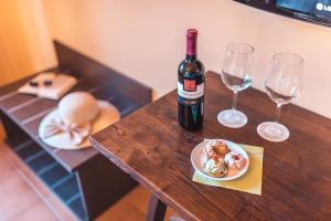 a table with a bottle of wine and two glasses at Hotel Villa Sirina in Taormina