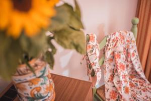 a pair of shoes sitting on a table next to a vase at Hotel Villa Sirina in Taormina