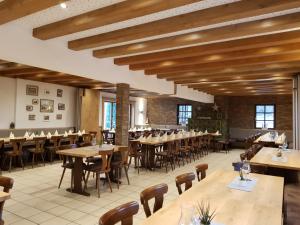a dining room with wooden tables and chairs at Gasthaus Dörsthof in Alzenau