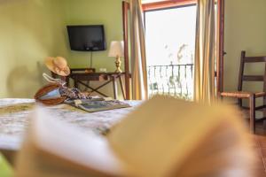 a room with a bed with a book and a window at Hotel Villa Sirina in Taormina