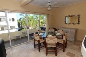 a dining room with a table and chairs and a window at Hotel Villamar Princesa Suites in Acapulco
