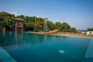 a large swimming pool with a slide and a playground at Yala Caravan Village in Kirinda