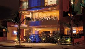 a building with lights in front of it at night at Blue Suites Hotel in Bogotá