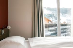 Postel nebo postele na pokoji v ubytování Club Hotel am Kreischberg