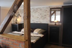 a bedroom with two beds and a brick wall at Festung Märcz in Pirna