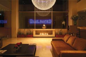 a living room with a couch and a fireplace at Blue Suites Hotel in Bogotá