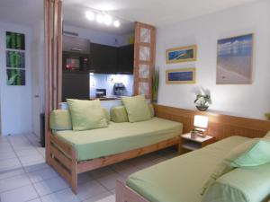 ビアリッツにあるstudio Victoria Surf Biarritzのリビングルーム(ベッド2台付)、キッチンが備わります。