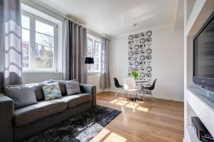 a living room with a couch and a table at Stylish Apartment in Heart of Oldtown in Gdańsk
