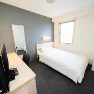 Voodi või voodid majutusasutuse Super Hotel Tokyo Kameido toas