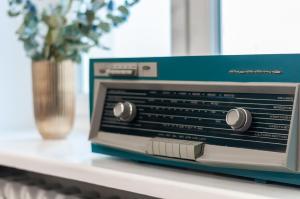 a toaster oven sitting on a counter with a vase at Apartments Monte Carlo Warsaw by Renters in Warsaw