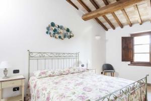 Agriturismo La Palazzetta di Assisi tesisinde bir odada yatak veya yataklar