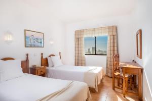 Una habitación de hotel con dos camas y una ventana. en Mirachoro Portimao, en Portimão 27 fotos más