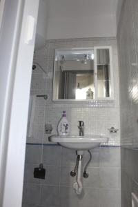 a bathroom with a sink and a mirror at Casa Azzurra in Castellammare del Golfo