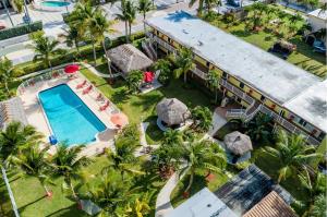 an aerial view of a resort with a swimming pool at Oceans Beach Resort & Suites in Pompano Beach