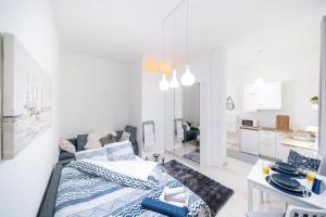 a living room with a bed and a kitchen at Deluxe Apartment Portić, self check-in in Zadar