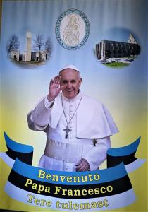 a poster of pope francis in front of monuments at Pirita Klooster in Tallinn