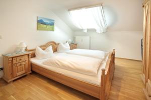 a bedroom with a large bed and a window at Bergblick in Fischen