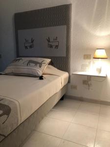 Postel nebo postele na pokoji v ubytování Hotel Canne al Vento