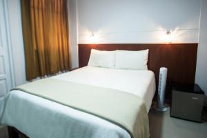 Postel nebo postele na pokoji v ubytování Hostal Vasco
