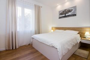 Posteľ alebo postele v izbe v ubytovaní Lugo Apartments