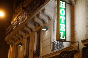 a neon sign on the side of a building at Hotel Pierre Nicole in Paris