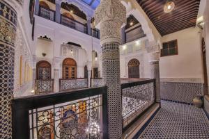 a staircase in a mosque with mosaics on the walls at Riad Ghita Palace in Fez