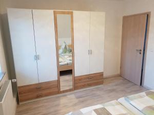 1 dormitorio con armarios blancos y 1 cama en Ferienwohnung Helena en Emden